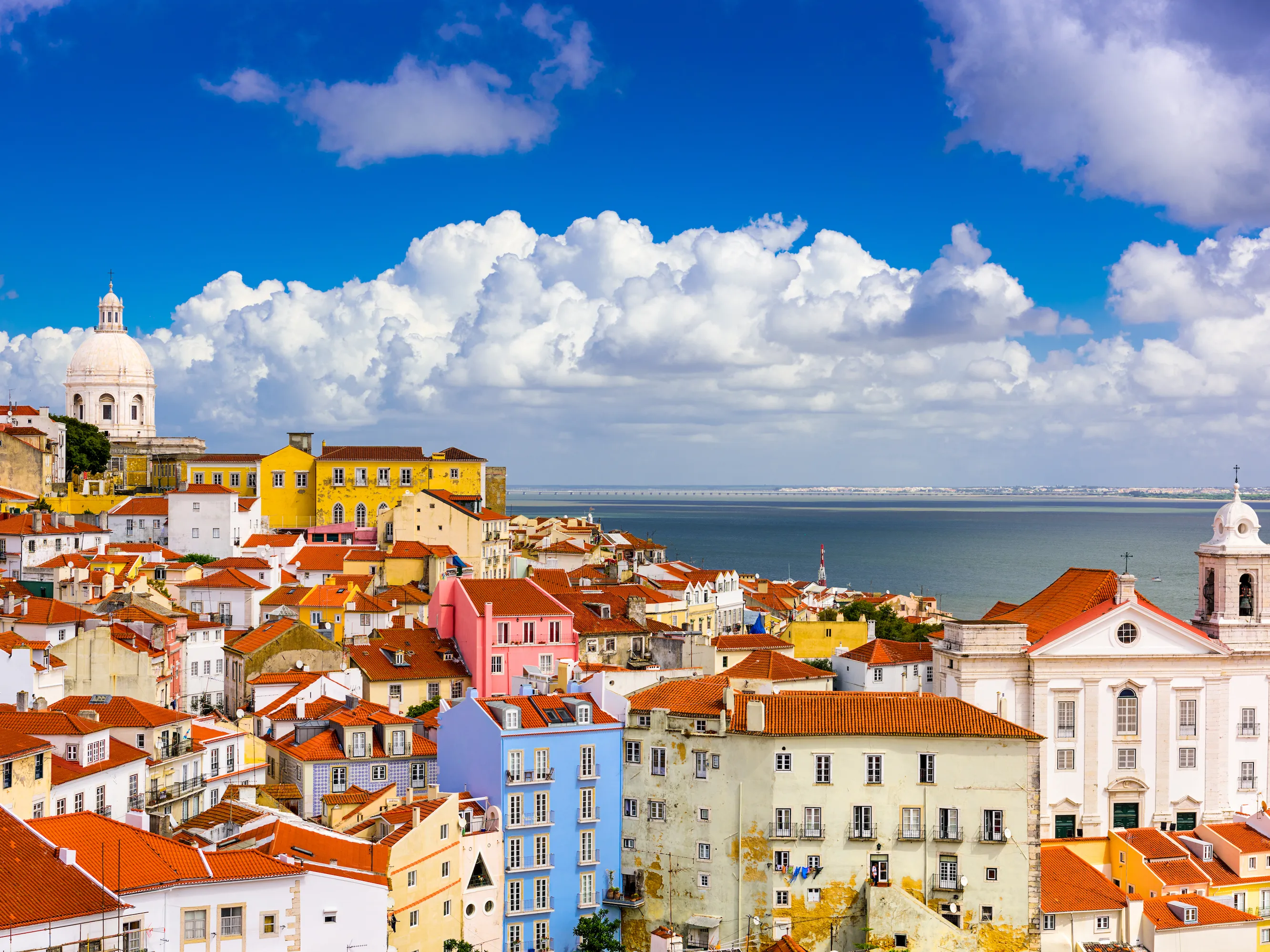 portrait shot of the city of Lisbon, showing various buildings of different shapes and colors.