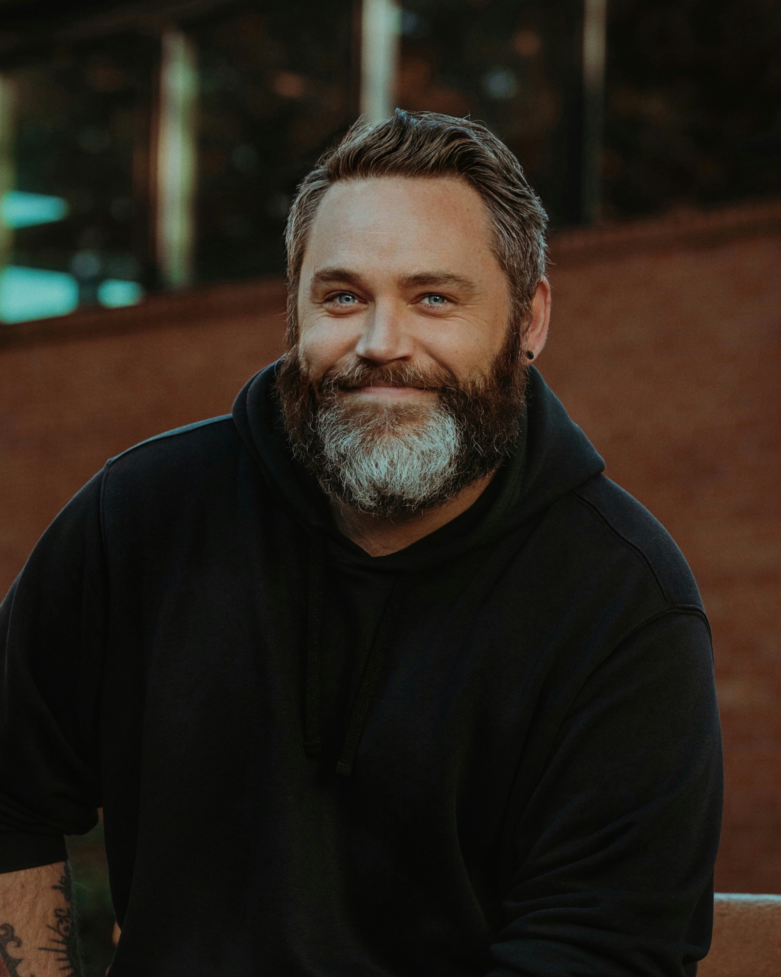 headshot of an older man with gray beard giving a slight smile