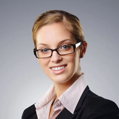 headshot of blonde woman wearing glasses in business formal